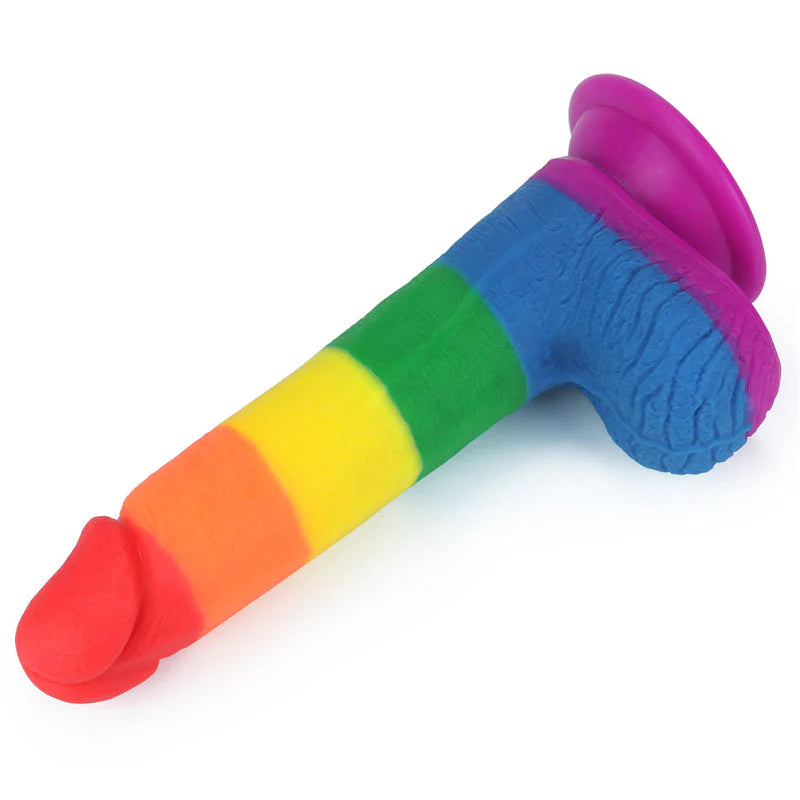 A colorful, curved anal dildo with a sturdy suction base, featuring vibrant rainbow colors with a red and blue gradient.