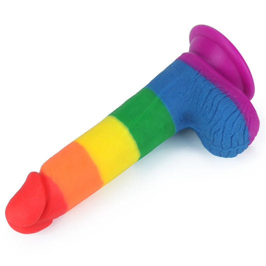 A colorful, curved anal dildo with a sturdy suction base, featuring vibrant rainbow colors with a red and blue gradient.